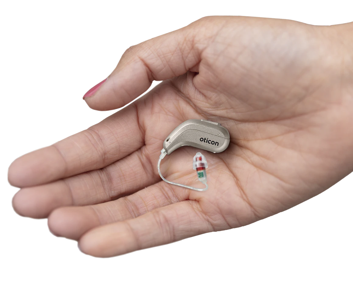 Oticon Intent hearing aids in a hand.