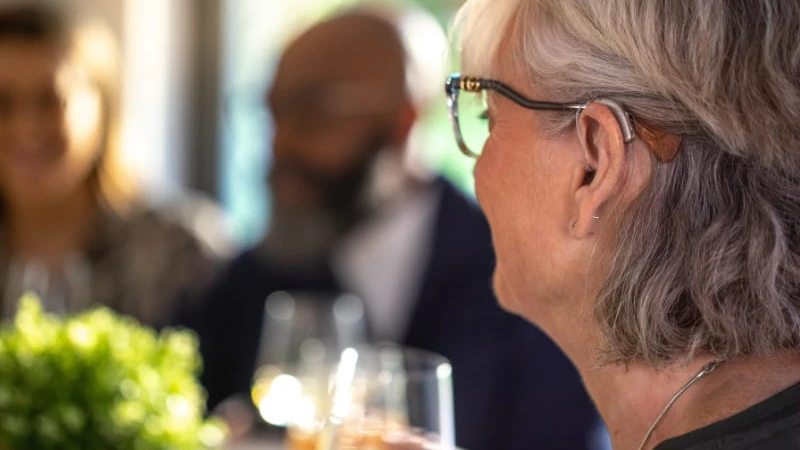 A woman wearing a hearing aid.